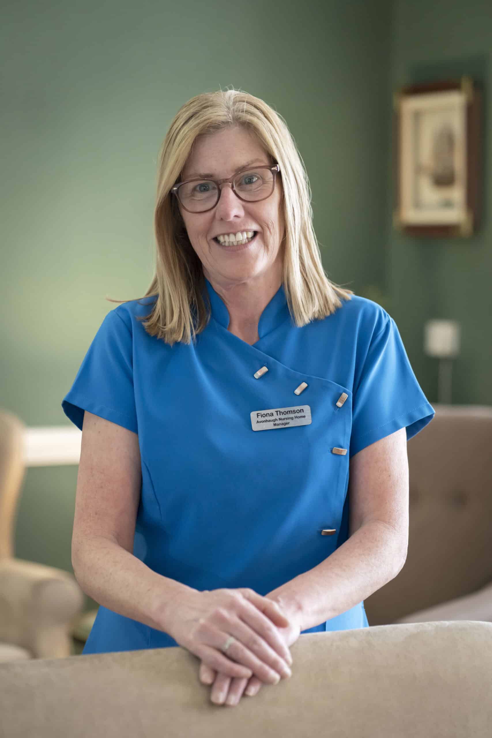 Care home staff member smiling in uniform at Avonhaugh.